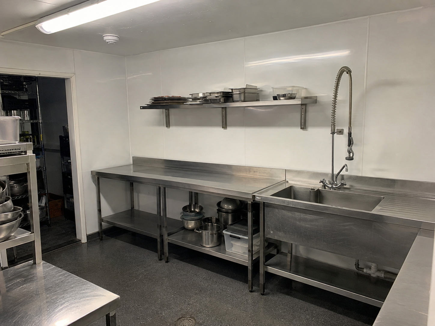 White hygienic PVC wall cladding along the prep and wash line of a commercial kitchen in Warminster, Wiltshire